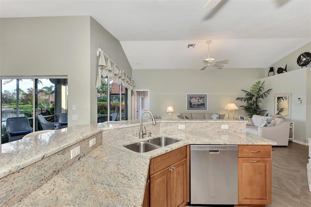 kitchen featuring ceiling fan, sink, lofted ceiling, light stone countertops, and stainless steel dishwasher