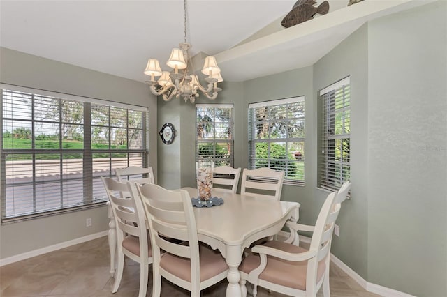 tiled dining area featuring a chandelier