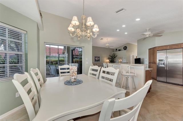 dining space with ceiling fan with notable chandelier and vaulted ceiling