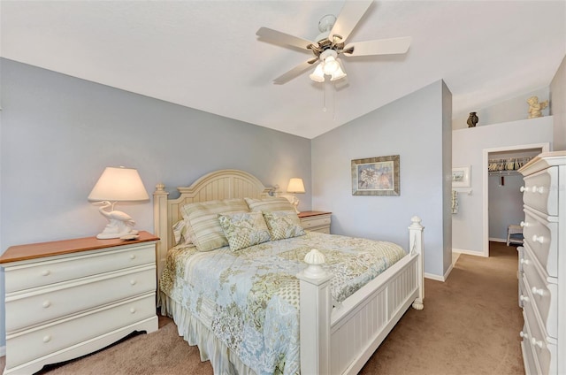 bedroom featuring light colored carpet, vaulted ceiling, and ceiling fan