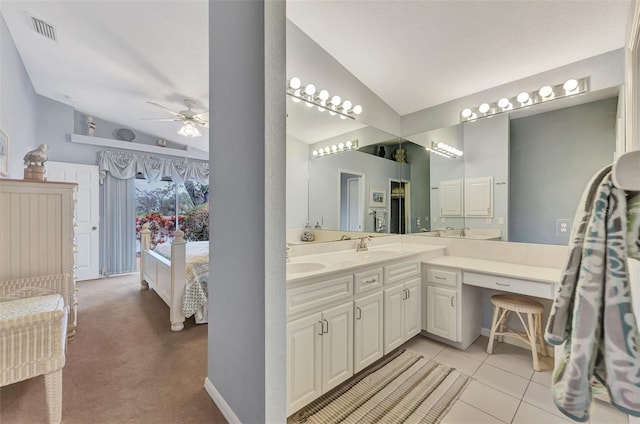 bathroom featuring ceiling fan, lofted ceiling, tile patterned flooring, and vanity