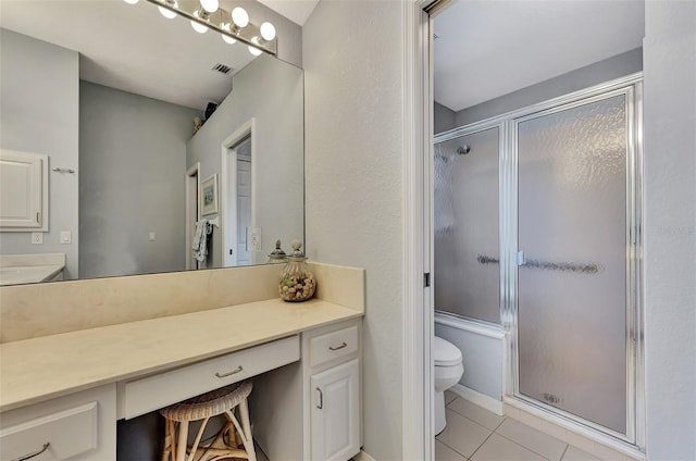 bathroom featuring walk in shower, tile patterned floors, vanity, and toilet