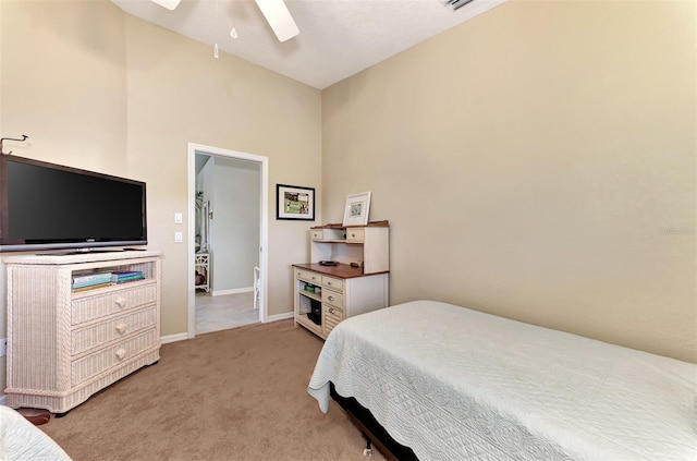 bedroom with baseboards, ceiling fan, and light carpet