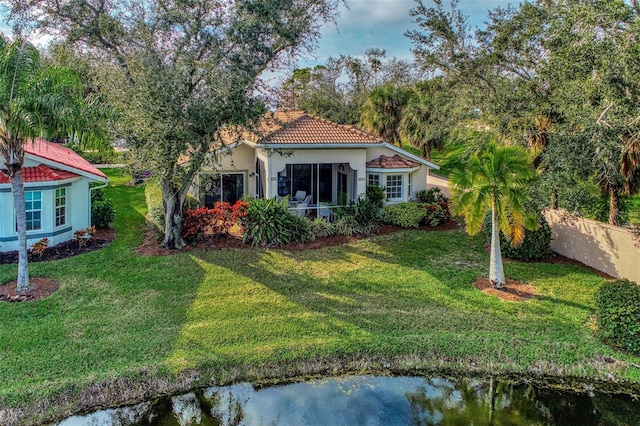 exterior space featuring a water view and a lawn