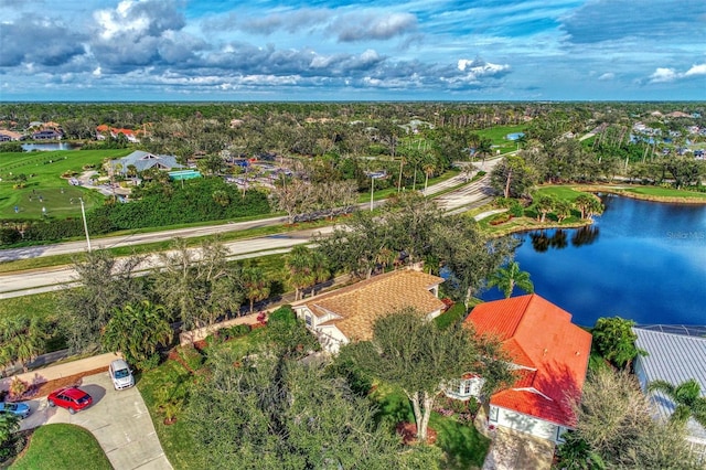 drone / aerial view featuring a water view, a residential view, and golf course view