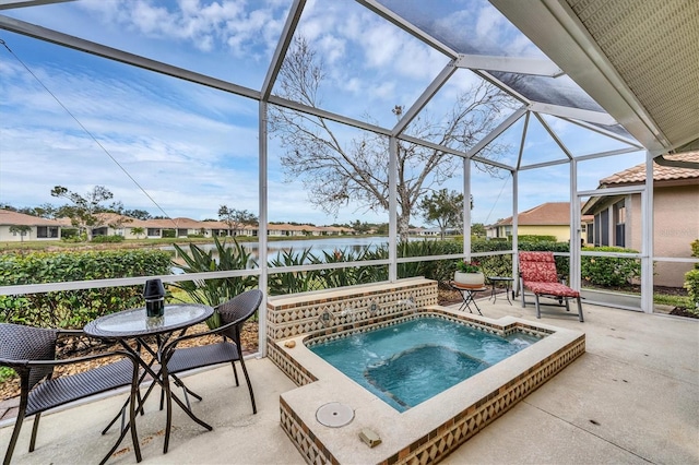 view of pool with a patio, a water view, and glass enclosure