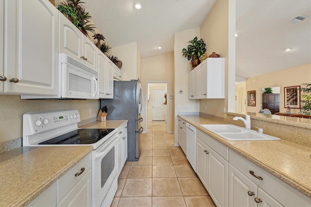 kitchen with lofted ceiling, sink, light tile patterned flooring, white cabinetry, and white appliances