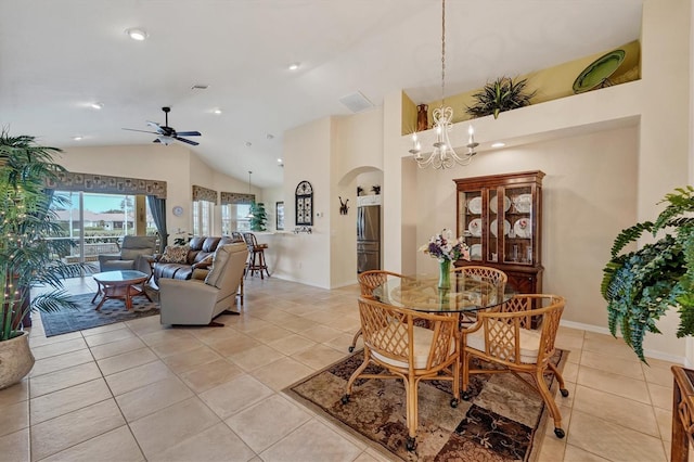 dining room featuring high vaulted ceiling, ceiling fan with notable chandelier, and light tile patterned floors