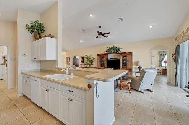 kitchen featuring light tile patterned flooring, sink, white dishwasher, kitchen peninsula, and white cabinets