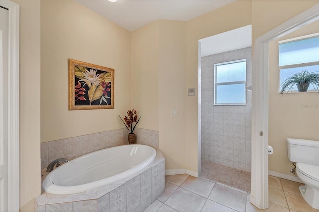 bathroom with tile patterned flooring, toilet, and separate shower and tub