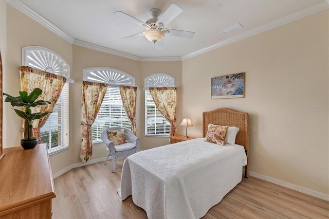 bedroom featuring ornamental molding, light wood-type flooring, and ceiling fan