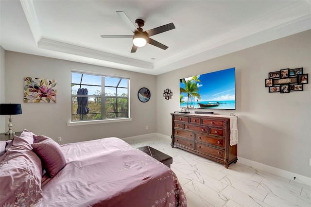 bedroom with a raised ceiling, ornamental molding, and ceiling fan