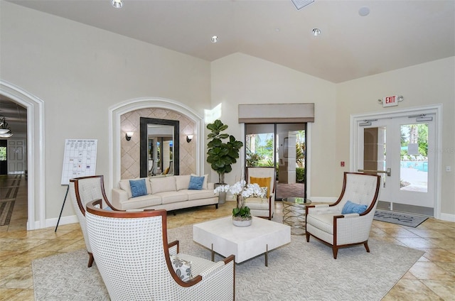 living room with vaulted ceiling, light tile patterned floors, and french doors