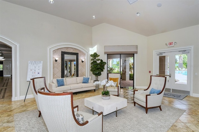 living area featuring baseboards, high vaulted ceiling, and light tile patterned floors