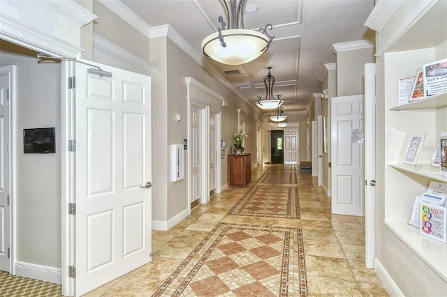 hall featuring baseboards, crown molding, and visible vents