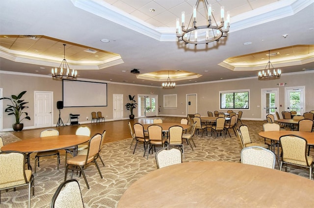 dining space with a chandelier, crown molding, and a raised ceiling