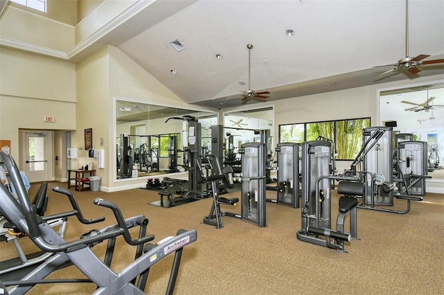 workout area with baseboards, visible vents, high vaulted ceiling, and ceiling fan