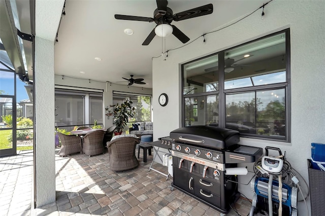 view of patio with ceiling fan, area for grilling, and a lanai