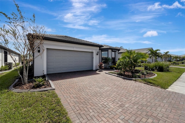 ranch-style house featuring a garage, central AC, and a front lawn