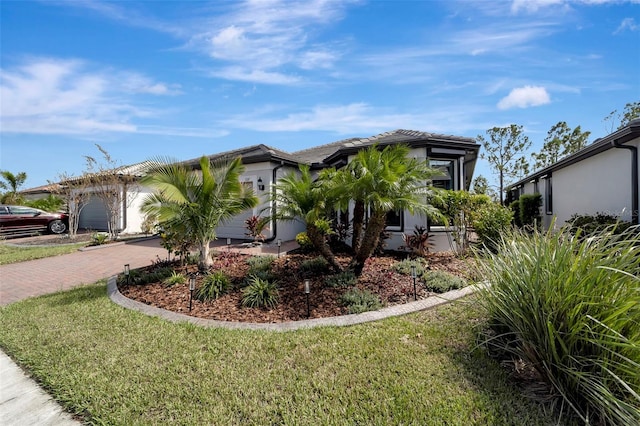 view of front of house featuring a garage and a front lawn