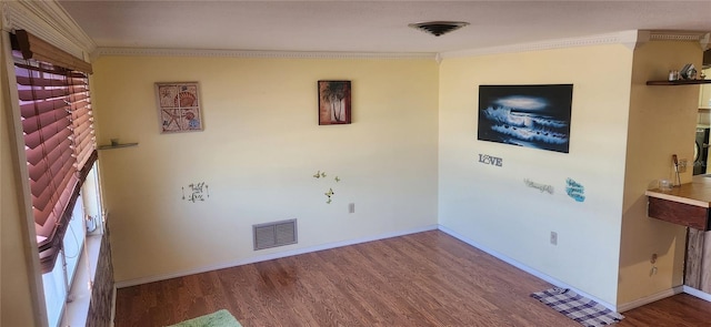 interior space with crown molding and hardwood / wood-style flooring