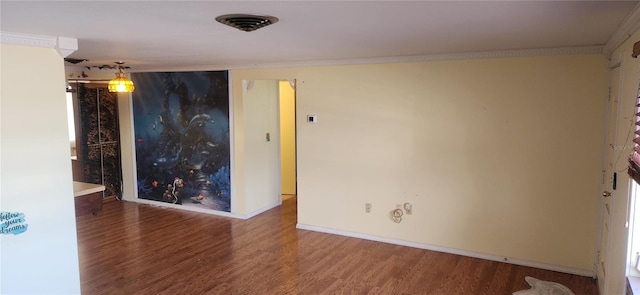 spare room with crown molding and hardwood / wood-style flooring