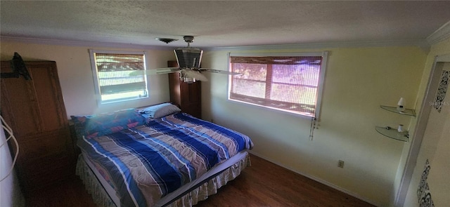 bedroom featuring ornamental molding, ceiling fan, a textured ceiling, and dark hardwood / wood-style flooring