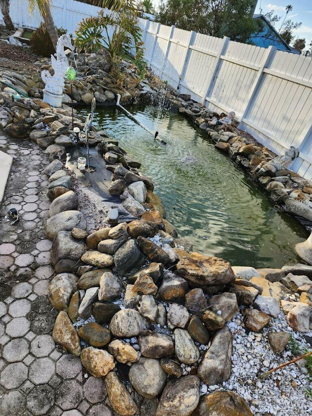 property view of water with a garden pond