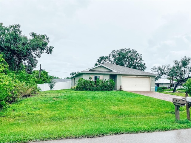 single story home featuring a garage and a front yard