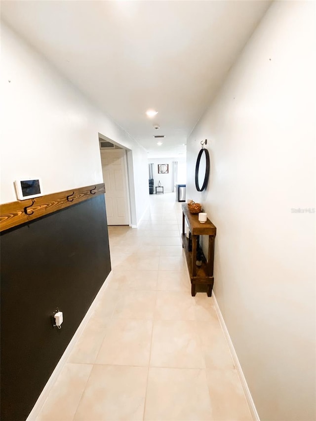 corridor with light tile patterned flooring