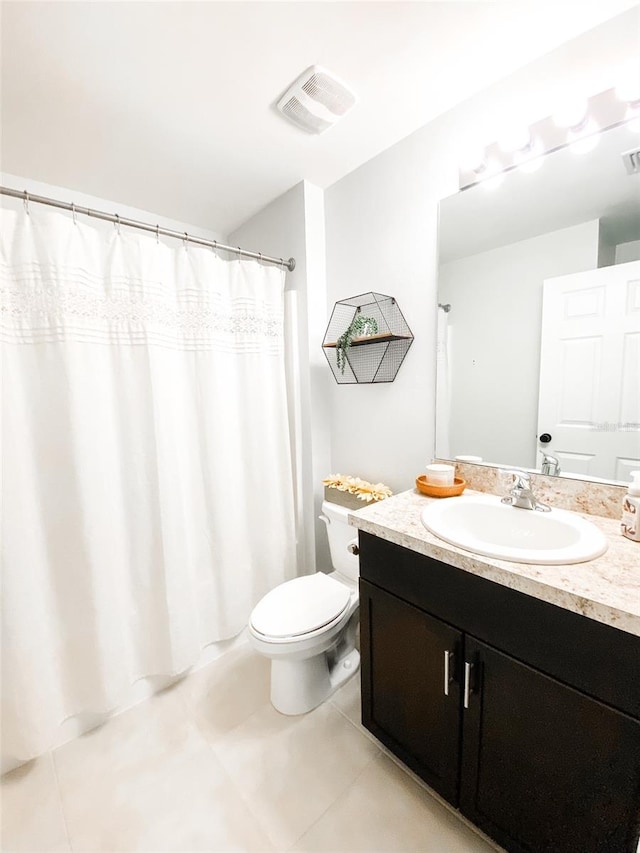 bathroom with tile patterned floors, a shower with shower curtain, vanity, and toilet