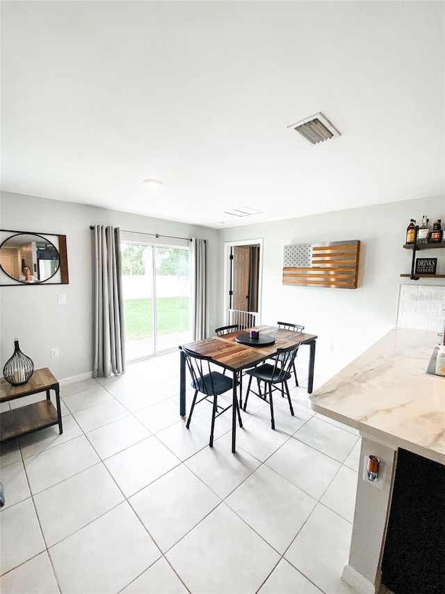 dining space featuring light tile patterned floors