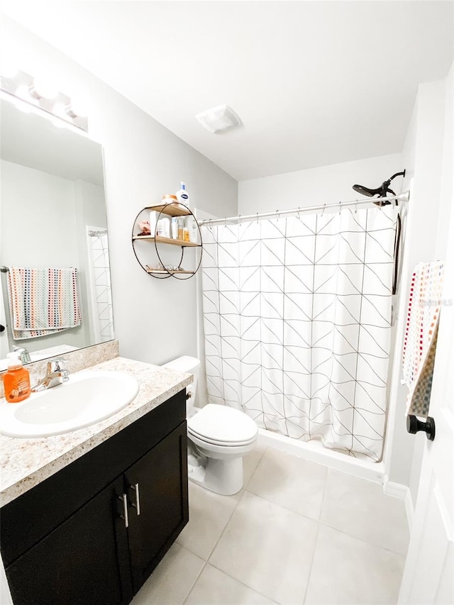 bathroom with tile patterned floors, toilet, vanity, and curtained shower