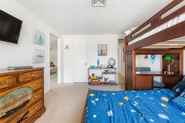 carpeted bedroom with a textured ceiling