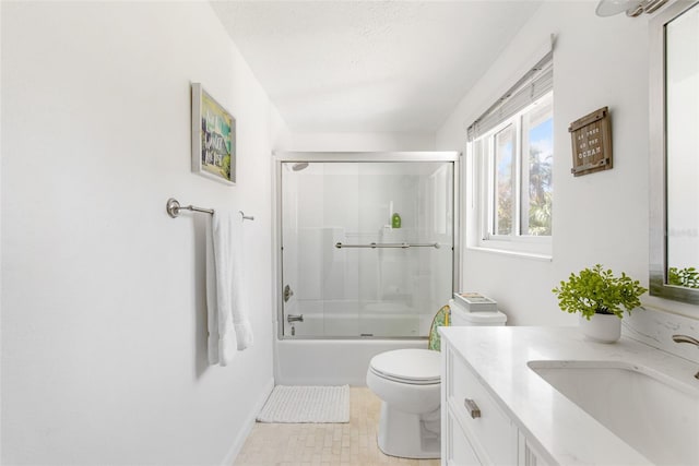 full bathroom featuring vanity, toilet, combined bath / shower with glass door, and a textured ceiling