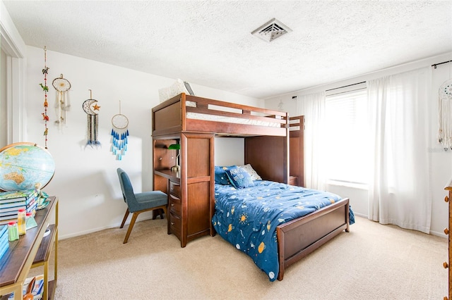 bedroom featuring a textured ceiling and carpet flooring