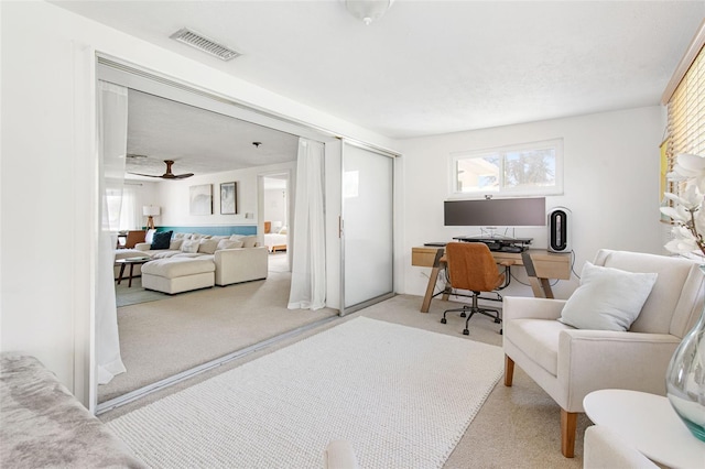 office space featuring light colored carpet and ceiling fan