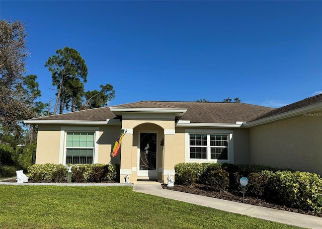 ranch-style house with a front lawn