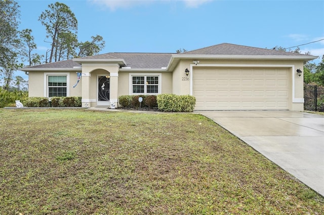 ranch-style home with a garage and a front yard