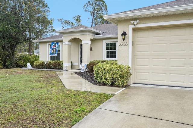 view of front of property featuring a garage and a front yard