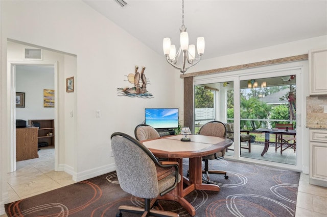 dining area with lofted ceiling, a chandelier, and light tile patterned floors