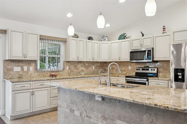 kitchen featuring stainless steel appliances, hanging light fixtures, sink, and light stone counters