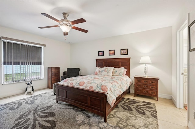 tiled bedroom featuring ceiling fan