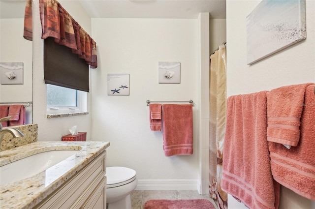 bathroom with tile patterned flooring, vanity, walk in shower, and toilet