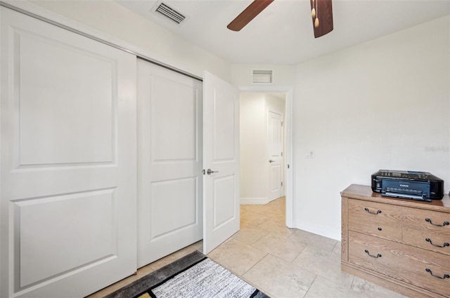 bedroom featuring a closet, ceiling fan, and light tile patterned flooring