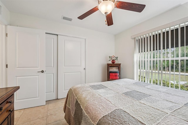 tiled bedroom featuring a closet and ceiling fan