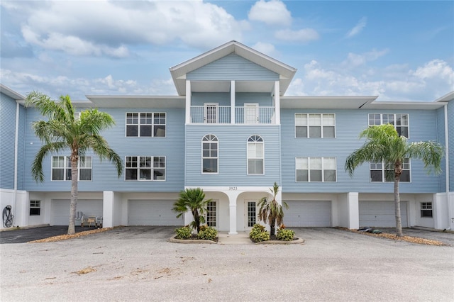 view of front facade featuring a balcony and a garage