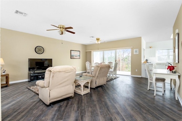 living room with dark wood-type flooring and ceiling fan