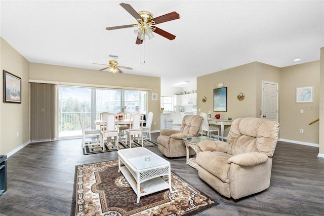 living room with ceiling fan and dark hardwood / wood-style flooring