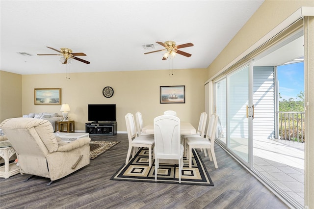 dining area with ceiling fan and dark hardwood / wood-style flooring